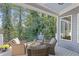 Charming covered patio with comfortable seating overlooks lush greenery, providing a tranquil and scenic retreat at 3441 Shoreland Dr, Buford, GA 30518