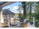 Relaxing patio area with wicker chairs, stunning lake views, and lush greenery provides a serene outdoor living space at 3441 Shoreland Dr, Buford, GA 30518