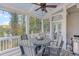Covered porch featuring stylish outdoor seating and string lights creates a cozy and inviting space for relaxation and gatherings at 3441 Shoreland Dr, Buford, GA 30518