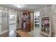 Spacious walk-in closet with custom wood cabinetry and a view into ensuite bathroom at 3441 Shoreland Dr, Buford, GA 30518