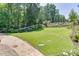 This spacious backyard features lush lawn and manicured landscaping, perfect for outdoor enjoyment at 3441 Shoreland Dr, Buford, GA 30518