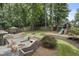 Backyard featuring a firepit, playset, pavilion, landscaping, and a well-maintained lawn at 3981 Longview Dr, Chamblee, GA 30341