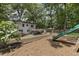 Beautiful backyard with large slide, seating area and wooded backdrop, creates a perfect space for play and relaxation at 3981 Longview Dr, Chamblee, GA 30341