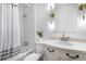 Bathroom showcasing a shower over tub, and vanity with decorative lights and white marble counters at 3981 Longview Dr, Chamblee, GA 30341