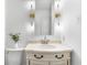 Bathroom showcasing a corner vanity with white marble counters, decorative lights, and white cabinets at 3981 Longview Dr, Chamblee, GA 30341