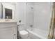 Bright bathroom featuring a shower-tub combo and a vanity with a marble countertop at 3981 Longview Dr, Chamblee, GA 30341
