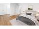 Bedroom with hardwood floors, neutral paint, a decorative bed, and an ensuite bathroom at 3981 Longview Dr, Chamblee, GA 30341