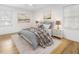 Bedroom with hardwood floors, neutral paint, and a decorative bed, with windows providing natural light at 3981 Longview Dr, Chamblee, GA 30341