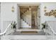 Inviting front entrance with double glass doors, elegant lighting fixtures, and stylish decor on a freshly painted white brick facade at 3981 Longview Dr, Chamblee, GA 30341