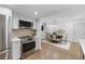 Bright kitchen featuring stainless steel appliances, modern cabinets, and a seamless transition into the adjacent dining area at 3981 Longview Dr, Chamblee, GA 30341