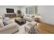 Bright living room featuring hardwood floors, comfortable seating, and ample natural light from a large window at 3981 Longview Dr, Chamblee, GA 30341