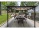 Outdoor dining area with a covered patio, table, and seating in a landscaped backyard at 3981 Longview Dr, Chamblee, GA 30341