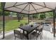 Covered outdoor dining area with table, chairs, and backyard play area at 3981 Longview Dr, Chamblee, GA 30341