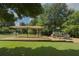 Community playground featuring a swing set and climbing structure, shaded by mature trees and canopy at 3981 Longview Dr, Chamblee, GA 30341