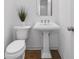 Clean powder room featuring classic fixtures, a pedestal sink, and neutral tones at 3981 Longview Dr, Chamblee, GA 30341
