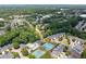 Overhead shot of townhome community with a pool, tennis courts, pond and mature trees at 4503 Kendall Way, Roswell, GA 30075