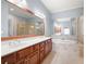 Ensuite bathroom featuring a double sink vanity, soaking tub, and glass shower at 4503 Kendall Way, Roswell, GA 30075