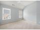This bedroom is brightly lit with two large windows and a ceiling fan at 4503 Kendall Way, Roswell, GA 30075