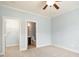 Bright bedroom featuring neutral carpet, a ceiling fan, walk-in closet and connecting bathroom at 4503 Kendall Way, Roswell, GA 30075