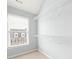 Walk in closet with white wire shelving and natural light from the window at 4503 Kendall Way, Roswell, GA 30075