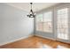 Bright dining room with hardwood floors, a modern chandelier, and a doorway to the deck at 4503 Kendall Way, Roswell, GA 30075