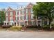 Attractive brick townhomes featuring a well-kept landscape, front entrances, and traditional design elements at 4503 Kendall Way, Roswell, GA 30075