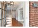 Bright foyer showcasing hardwood floors and an open staircase, leading to a welcoming living space at 4503 Kendall Way, Roswell, GA 30075