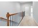 Upstairs hallway with wood railing and neutral carpeting at 4503 Kendall Way, Roswell, GA 30075