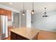 Open kitchen layout featuring a granite island, stainless steel refrigerator, and adjacent dining area at 4503 Kendall Way, Roswell, GA 30075