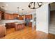 Open kitchen layout with wood cabinets, stainless steel appliances and an island with granite countertops at 4503 Kendall Way, Roswell, GA 30075