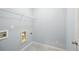 Laundry room with white wire shelving and hookups for the washer and dryer at 4503 Kendall Way, Roswell, GA 30075