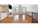 Spacious living room featuring hardwood floors, a fireplace, built-ins, and natural light from large windows at 4503 Kendall Way, Roswell, GA 30075