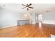 Spacious living area featuring beautiful hardwood floors, staircase with black railing, and neutral walls at 4503 Kendall Way, Roswell, GA 30075