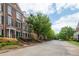 Brick townhouses along a tree-lined street with well-manicured lawns and landscaping at 4503 Kendall Way, Roswell, GA 30075