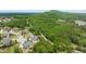 An aerial view features stunning mountain and tree top views of this beautiful neighborhood at 5075 Havenbrooke Ct, Cumming, GA 30040