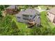 Aerial view of a backyard with a black fence, wooden deck and lots of trees at 5075 Havenbrooke Ct, Cumming, GA 30040