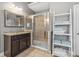 Bathroom with glass shower, vanity with granite countertop, and linen storage at 5075 Havenbrooke Ct, Cumming, GA 30040