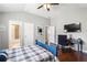Bedroom with hardwood floors, desk, ceiling fan, and an ensuite bathroom at 5075 Havenbrooke Ct, Cumming, GA 30040