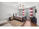 Cozy bedroom with hardwood floors, ceiling fan, and large window with bright striped curtains at 5075 Havenbrooke Ct, Cumming, GA 30040