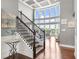 Grand foyer with staircase, hardwood floors, floor-to-ceiling windows, and coffered ceilings at 5075 Havenbrooke Ct, Cumming, GA 30040