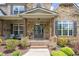 Charming stone home with a covered front porch and double doors for a welcoming entrance at 5075 Havenbrooke Ct, Cumming, GA 30040