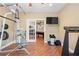 Bright gym features fitness equipment, natural light, and hardwood floors at 5075 Havenbrooke Ct, Cumming, GA 30040