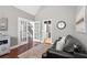 Cozy Living Room featuring hardwood floors, a leather couch, and glass paneled doors at 5075 Havenbrooke Ct, Cumming, GA 30040