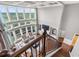 A view from the stairs to the living room which features soaring ceilings and tall windows with plenty of natural light at 5075 Havenbrooke Ct, Cumming, GA 30040