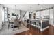 Open concept living space with hardwood floors featuring a table with chairs and a kitchen island at 5075 Havenbrooke Ct, Cumming, GA 30040