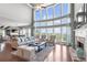 Spacious living room with a wall of windows, fireplace and hardwood floors at 5075 Havenbrooke Ct, Cumming, GA 30040