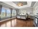 Inviting main bedroom features hardwood floors, large windows for natural light and neutral walls at 5075 Havenbrooke Ct, Cumming, GA 30040