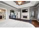 Spacious main bedroom suite features tray ceilings, a fireplace, and hardwood floors at 5075 Havenbrooke Ct, Cumming, GA 30040