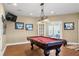 Finished basement featuring a pool table under decorative lighting, framed jerseys on wall at 5075 Havenbrooke Ct, Cumming, GA 30040