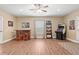 Recreation room featuring hardwood floors, bar, arcade game, and natural light at 5075 Havenbrooke Ct, Cumming, GA 30040